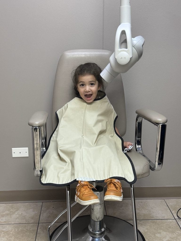 a child at All Star Dental sitting in a chair about to receive an x-ray